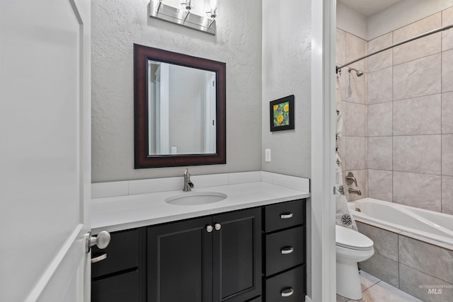18279 N Tulip Ave, Nampa, ID 83687 - bathroom featuring a textured wall, tile patterned flooring, vanity, toilet, and tiled shower / bath combo