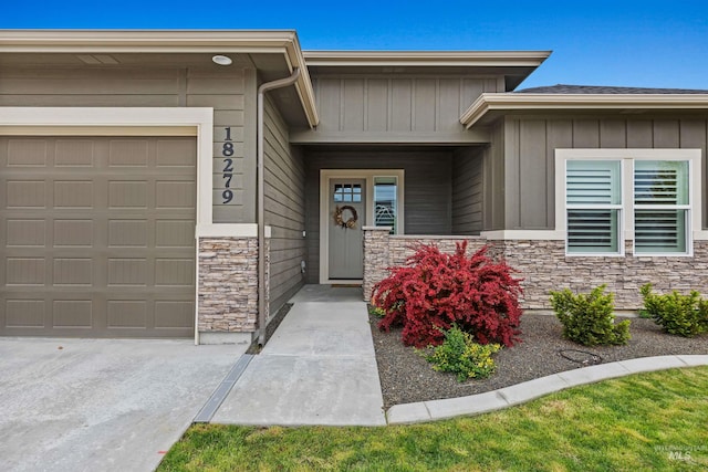18279 N Tulip Ave, Nampa, ID 83687 - entrance to property with board and batten siding, an attached garage, and stone siding
