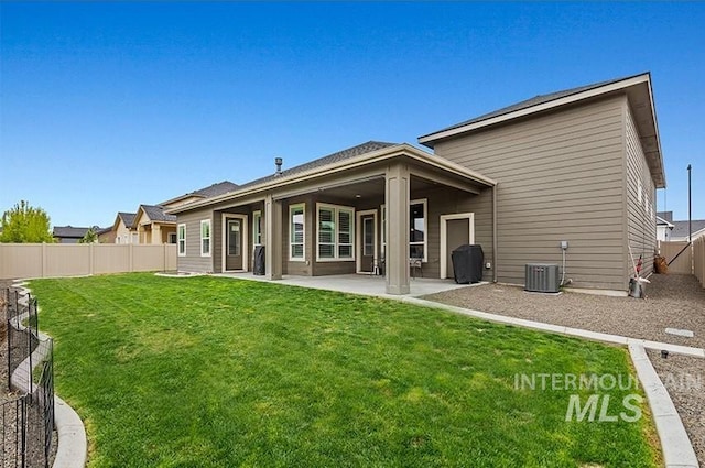 18279 N Tulip Ave, Nampa, ID 83687 - rear view of property with a fenced backyard, a yard, a patio area, and cooling unit