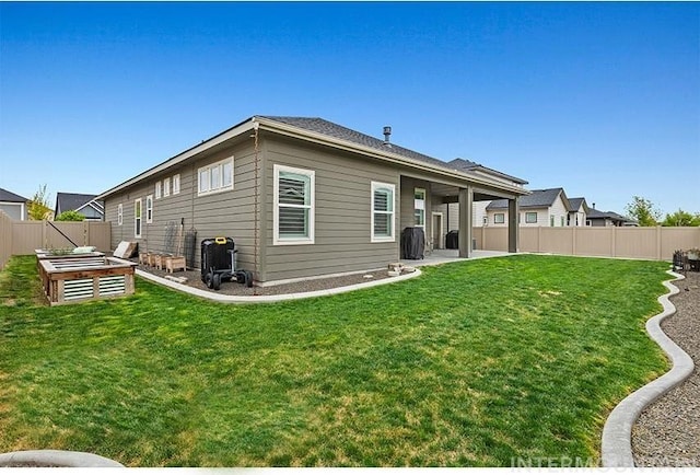 18279 N Tulip Ave, Nampa, ID 83687 - back of house with a fenced backyard, a yard, and a patio area