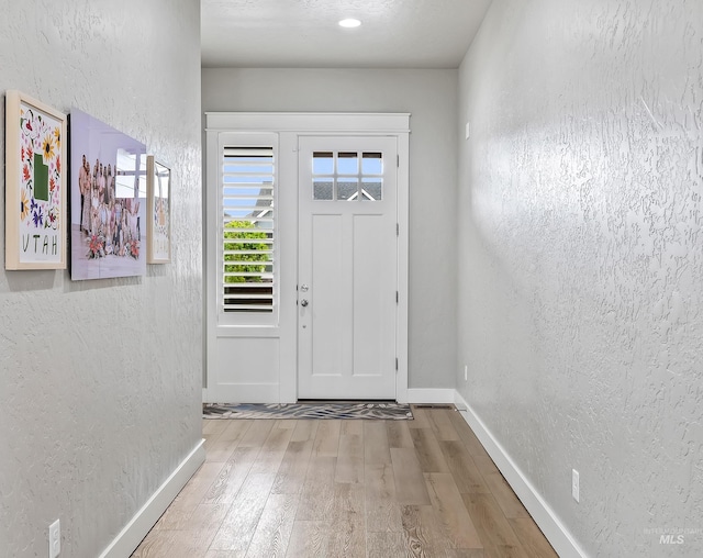 18279 N Tulip Ave, Nampa, ID 83687 - foyer featuring baseboards, a textured wall, and wood finished floors