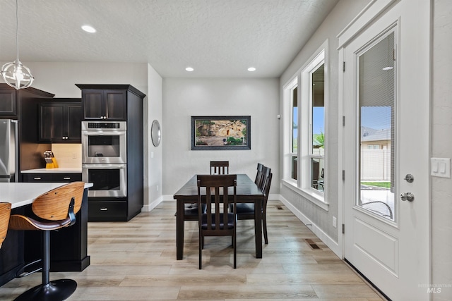 18279 N Tulip Ave, Nampa, ID 83687 - dining space featuring recessed lighting, a textured ceiling, visible vents, and light wood finished floors