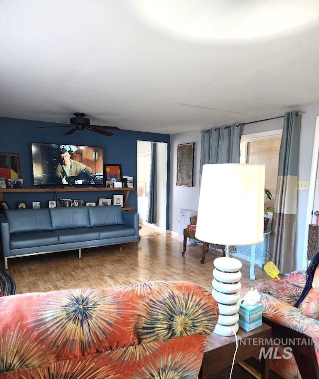 living room featuring ceiling fan and hardwood / wood-style floors