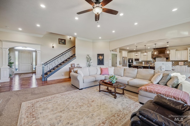 2466 Brooks Dr, Fruitland, ID 83619 - living area featuring decorative columns, crown molding, ceiling fan, arched walkways, and recessed lighting