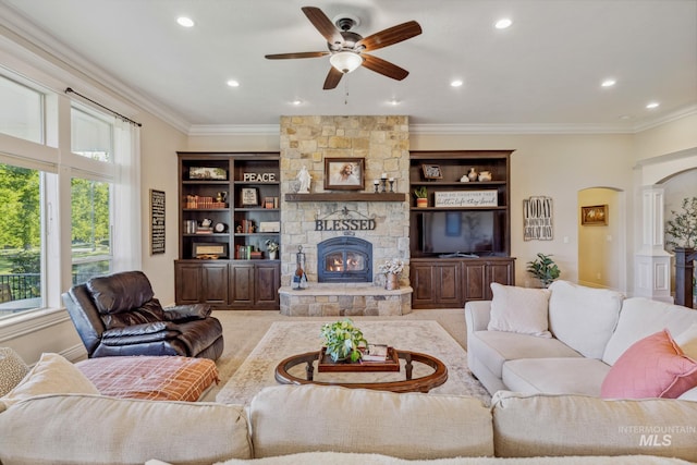 2466 Brooks Dr, Fruitland, ID 83619 - living area with a stone fireplace, ceiling fan, recessed lighting, crown molding, and arched walkways