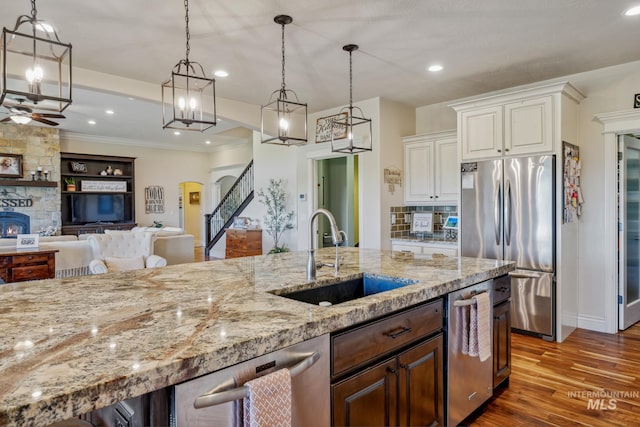 2466 Brooks Dr, Fruitland, ID 83619 - kitchen featuring appliances with stainless steel finishes, a sink, light stone countertops, decorative light fixtures, and recessed lighting