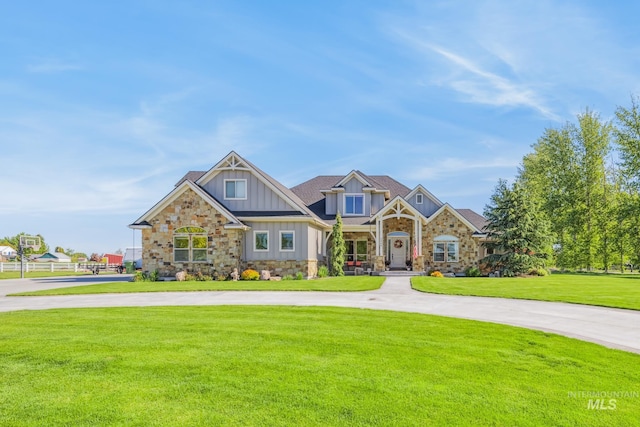 2466 Brooks Dr, Fruitland, ID 83619 - craftsman-style house featuring board and batten siding, curved driveway, a front lawn, and stone siding