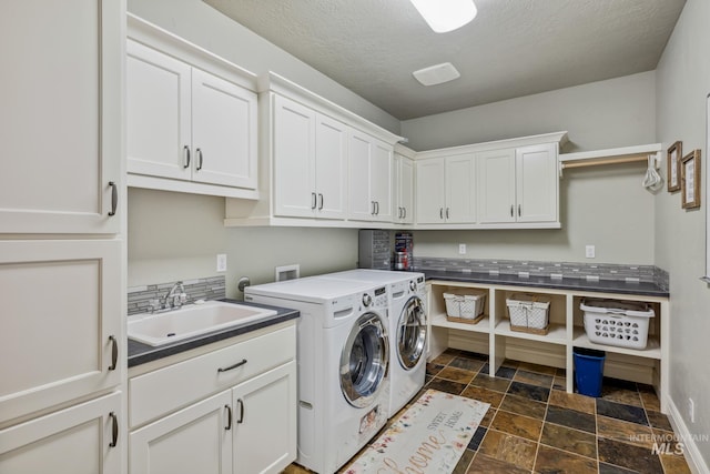 2466 Brooks Dr, Fruitland, ID 83619 - laundry area featuring cabinet space, dark stone finish floors, and washer and clothes dryer
