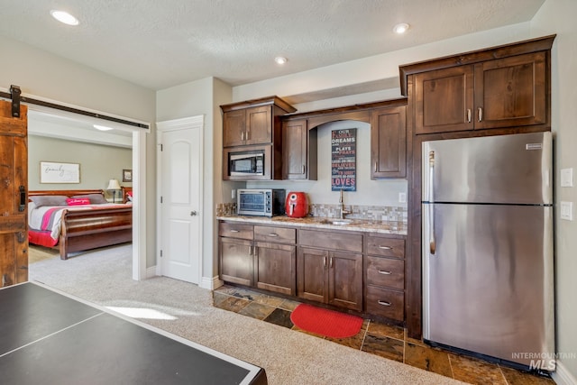 2466 Brooks Dr, Fruitland, ID 83619 - kitchen featuring appliances with stainless steel finishes, dark colored carpet, light countertops, a sink, and recessed lighting