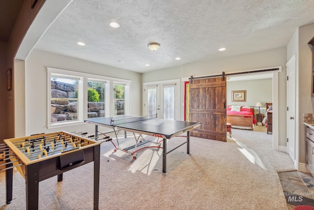 2466 Brooks Dr, Fruitland, ID 83619 - playroom featuring recessed lighting, carpet, a barn door, a textured ceiling, and french doors