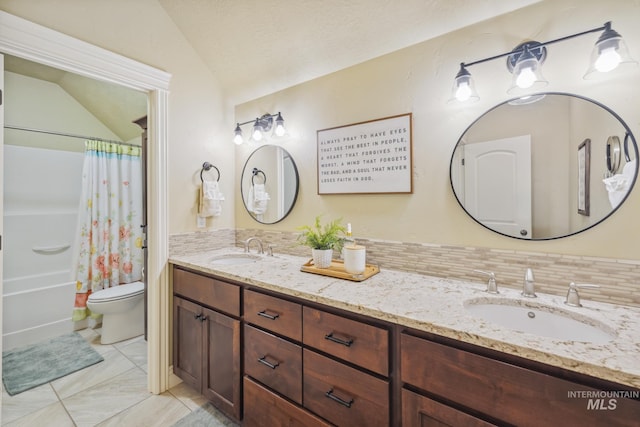 2466 Brooks Dr, Fruitland, ID 83619 - bathroom featuring vaulted ceiling, double vanity, toilet, shower / tub combo with curtain, and decorative backsplash