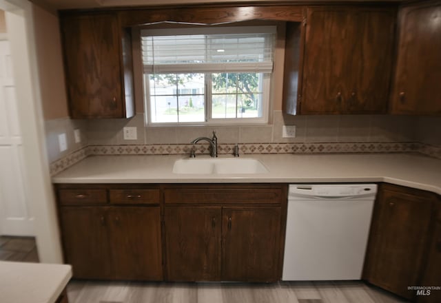 8395 W Golse Dr, Boise, ID 83704 - kitchen featuring white dishwasher, light countertops, a sink, and dark brown cabinetry