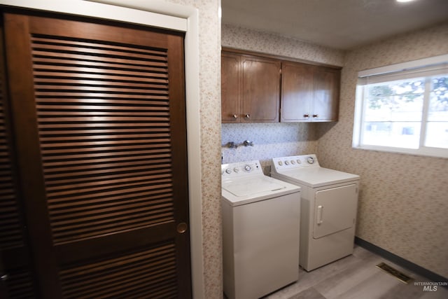 8395 W Golse Dr, Boise, ID 83704 - laundry room featuring wallpapered walls, visible vents, light wood-style floors, separate washer and dryer, and cabinet space