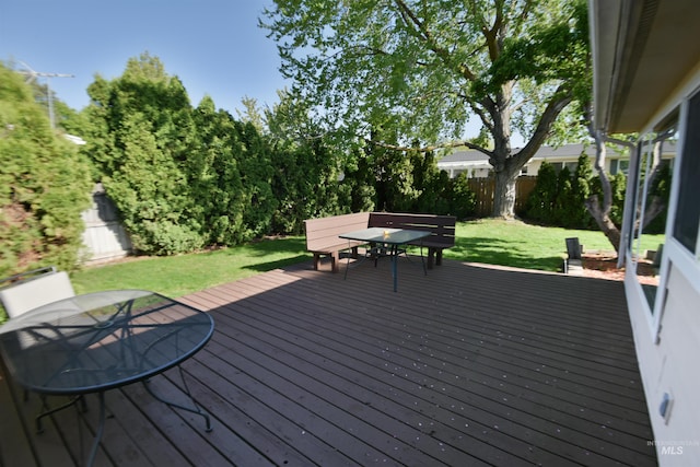 8395 W Golse Dr, Boise, ID 83704 - wooden deck with a lawn, outdoor dining area, and a fenced backyard