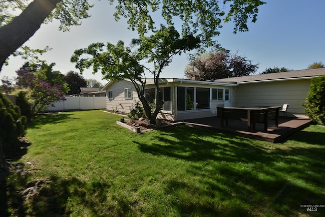 8395 W Golse Dr, Boise, ID 83704 - rear view of property with a sunroom, a lawn, a wooden deck, and a fenced backyard
