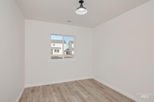 spare room with light wood-type flooring