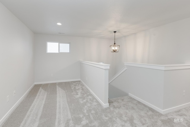 basement featuring carpet floors, recessed lighting, an inviting chandelier, and baseboards