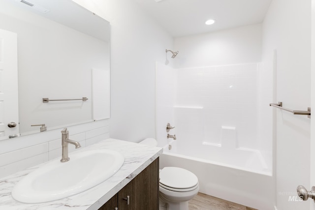 bathroom with shower / washtub combination, visible vents, backsplash, toilet, and vanity