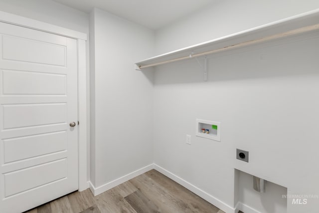 washroom with light wood-style flooring, laundry area, washer hookup, baseboards, and electric dryer hookup