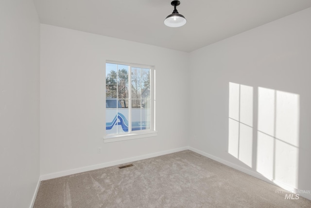 unfurnished room with light carpet