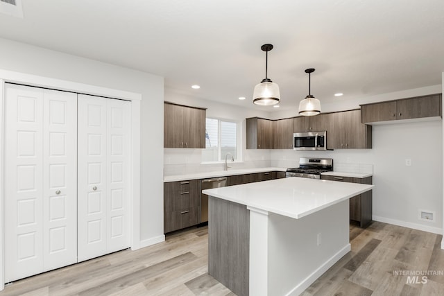 kitchen featuring light wood finished floors, modern cabinets, and stainless steel appliances