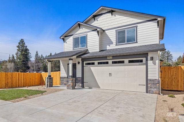 6303 W Stavros Dr, Meridian, ID 83646 - craftsman-style house with stone siding, an attached garage, fence, and concrete driveway