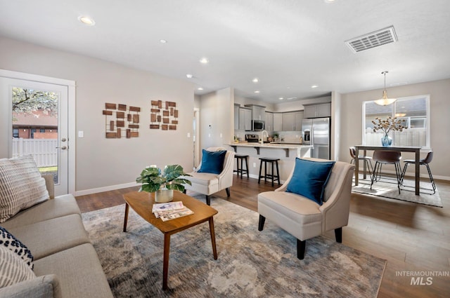 6303 W Stavros Dr, Meridian, ID 83646 - living area featuring wood finished floors, baseboards, and recessed lighting