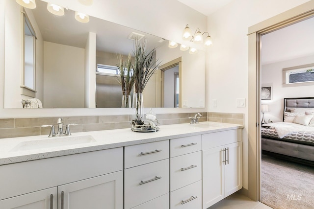 6303 W Stavros Dr, Meridian, ID 83646 - bathroom featuring ensuite bathroom, double vanity, and decorative backsplash
