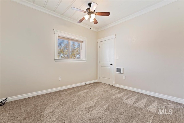 spare room with a ceiling fan, baseboards, light colored carpet, and ornamental molding