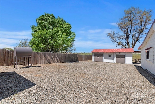 view of yard with an outbuilding and a fenced backyard