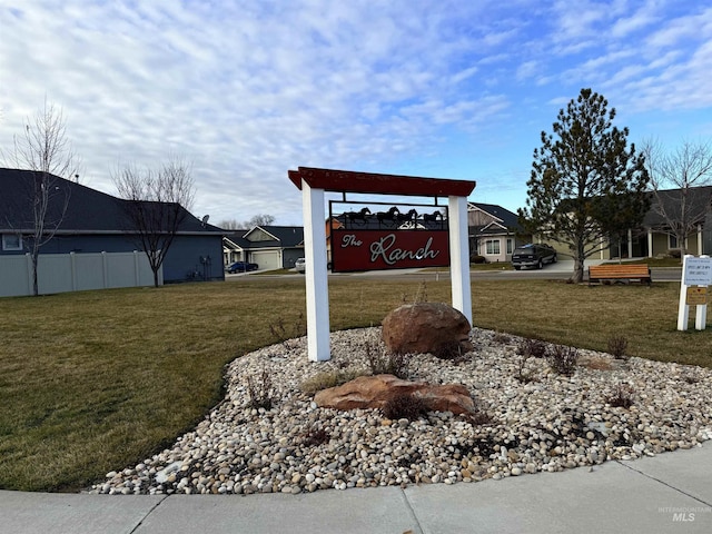 community sign featuring a yard