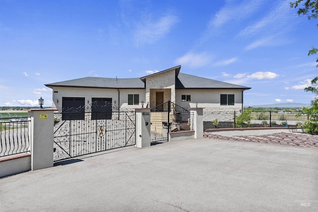 5990 W View Dr, Meridian, ID 83642 - view of front of property featuring a gate, a garage, stucco siding, and stone siding