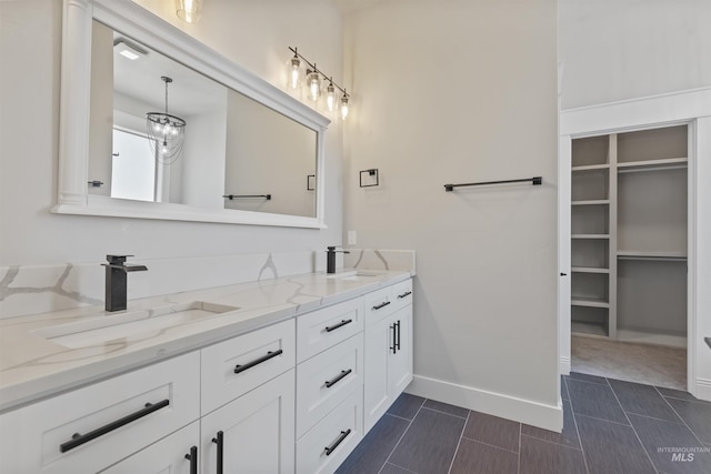 5990 W View Dr, Meridian, ID 83642 - bathroom with double vanity, tile patterned flooring, baseboards, and a walk in closet