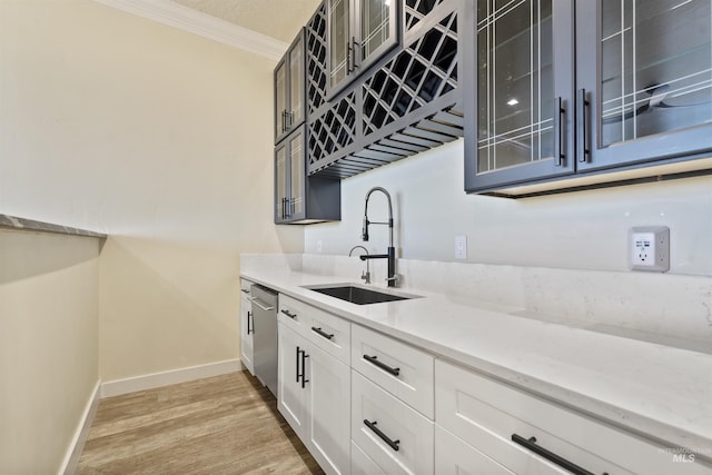 5990 W View Dr, Meridian, ID 83642 - kitchen with a sink, ornamental molding, stainless steel dishwasher, light stone countertops, and glass insert cabinets