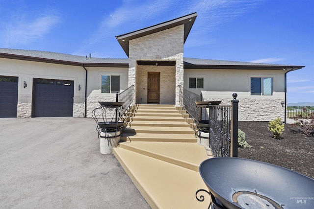 5990 W View Dr, Meridian, ID 83642 - view of front facade with stone siding, a garage, and driveway