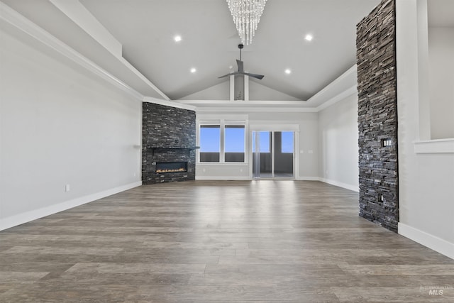 5990 W View Dr, Meridian, ID 83642 - unfurnished living room with a fireplace, lofted ceiling, wood finished floors, a ceiling fan, and a chandelier