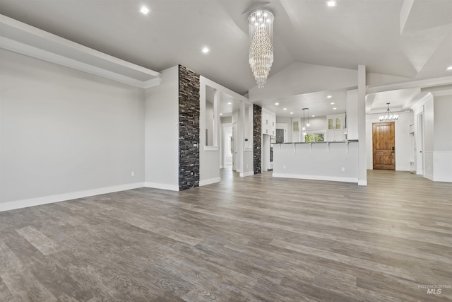 5990 W View Dr, Meridian, ID 83642 - unfurnished living room with a chandelier, wood finished floors, vaulted ceiling, and baseboards