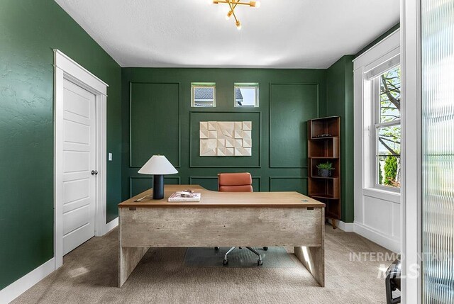 home office with a decorative wall, carpet flooring, and plenty of natural light