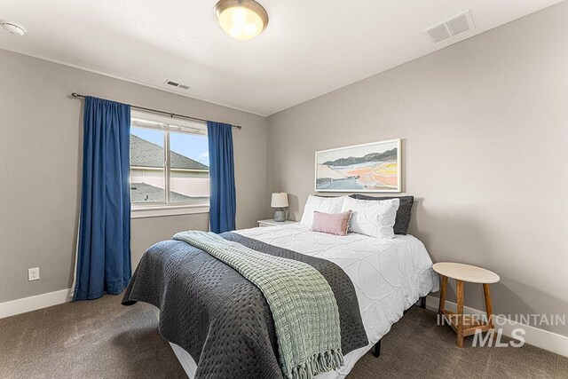 bedroom with carpet floors, visible vents, and baseboards