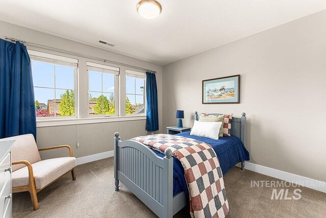 bedroom featuring baseboards, visible vents, and carpet flooring