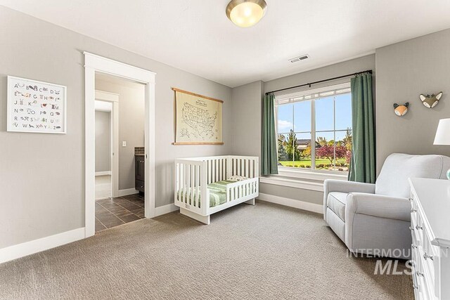 carpeted bedroom with visible vents and baseboards