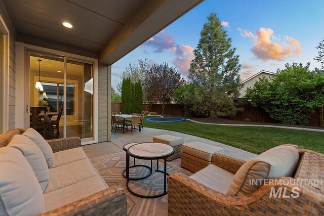 view of patio / terrace with a fenced backyard, outdoor dining space, and an outdoor hangout area