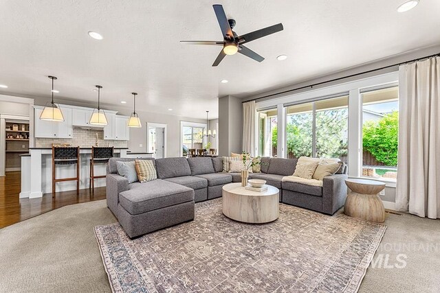 carpeted living room with a ceiling fan and recessed lighting