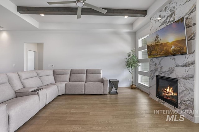 2252 Detweiler Pl, Twin Falls, ID 83301 - living room with a high end fireplace, baseboards, wood finished floors, a ceiling fan, and beam ceiling