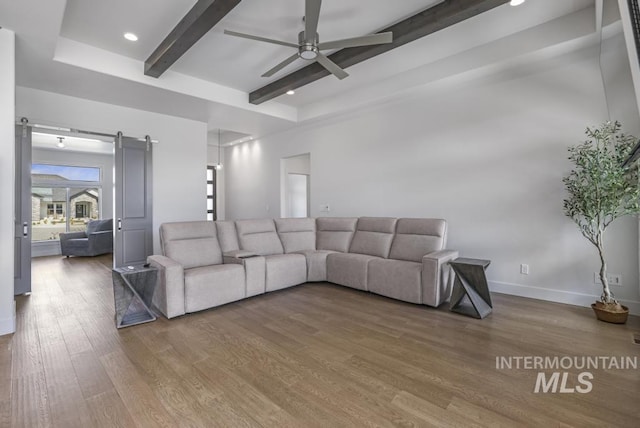 2252 Detweiler Pl, Twin Falls, ID 83301 - living area with baseboards, a barn door, beamed ceiling, ceiling fan, and wood finished floors