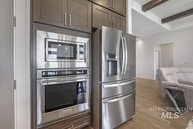 2252 Detweiler Pl, Twin Falls, ID 83301 - kitchen featuring beam ceiling, dark brown cabinets, appliances with stainless steel finishes, and light wood finished floors