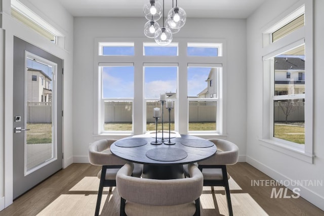 2252 Detweiler Pl, Twin Falls, ID 83301 - dining space featuring baseboards, wood finished floors, and an inviting chandelier