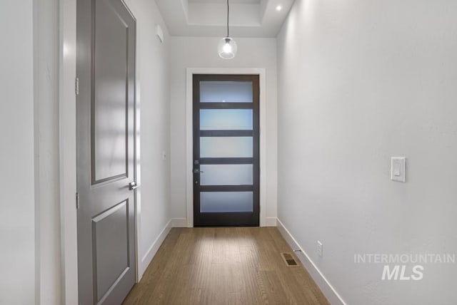 2252 Detweiler Pl, Twin Falls, ID 83301 - doorway with baseboards, visible vents, wood finished floors, and a raised ceiling