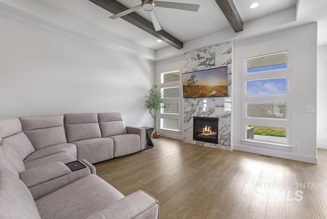 2252 Detweiler Pl, Twin Falls, ID 83301 - living area featuring a premium fireplace, beamed ceiling, baseboards, ceiling fan, and wood finished floors