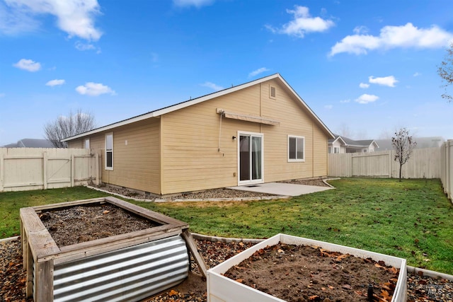 rear view of house featuring a yard